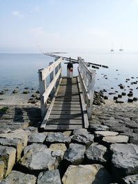 Pier over sea against sky