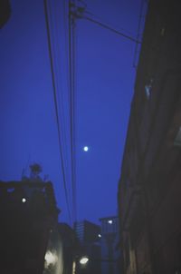 Low angle view of illuminated street light at night