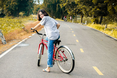 Woman riding bicycle on road