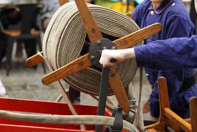 People spinning rope on wheel