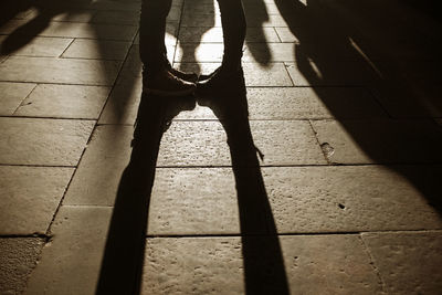 Low section of woman standing on tiled floor