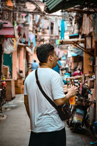 Rear view of man standing in market