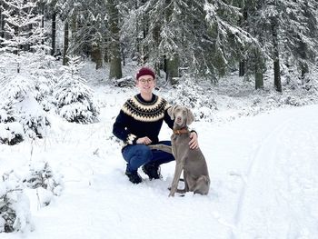 Guy with weimaraner dog in snow