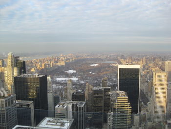 Aerial view of buildings in city against sky