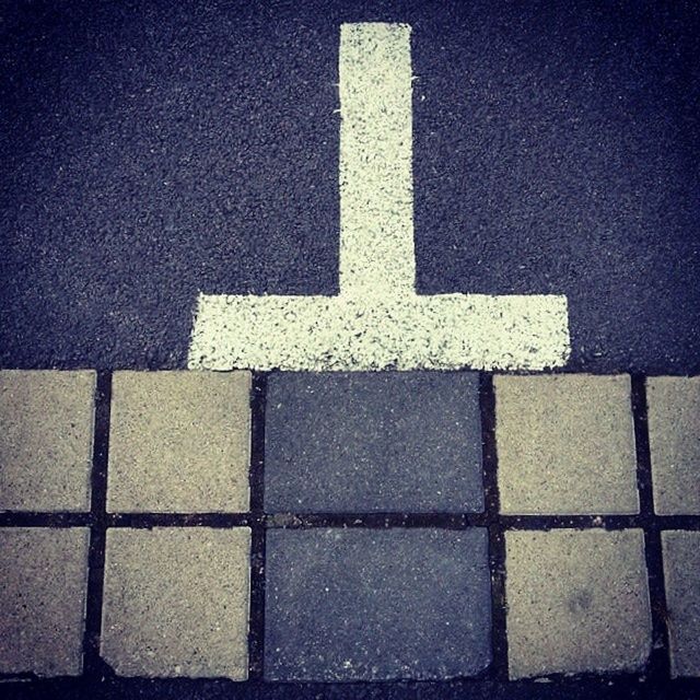 full frame, textured, backgrounds, pattern, high angle view, street, road marking, close-up, no people, asphalt, wall - building feature, geometric shape, white color, outdoors, architecture, built structure, guidance, road, shadow, day