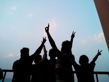 Silhouette people against sky