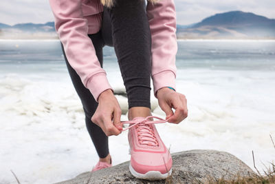 Running woman. runner is jogging in winter day. female fitness training outdoors around mountains.