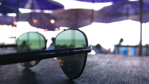 Close-up of sunglasses on glass table