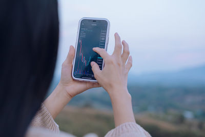 Midsection of woman using mobile phone