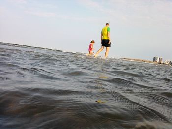 People on beach against sky