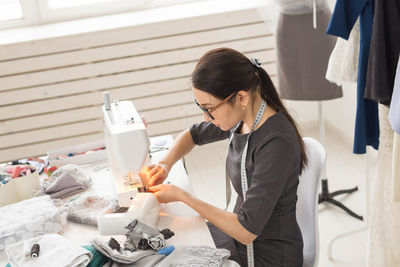 Side view of woman working in kitchen