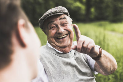 Portrait of laughing senior man talking to his grandson