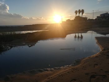 Scenic view of lake against sky during sunset