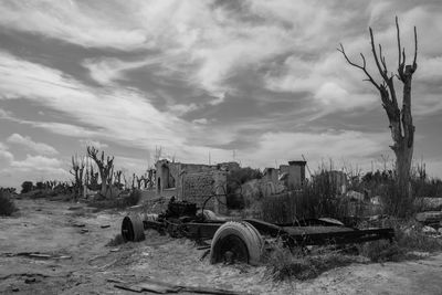 Abandoned built structure on field against sky