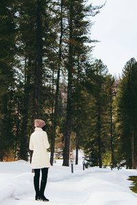 Woman standing on snow covered land