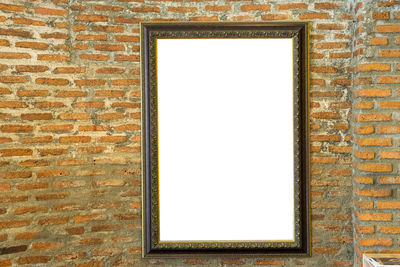 Low angle view of window on brick wall