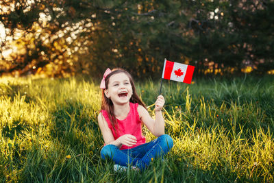 Portrait of girl sitting on field