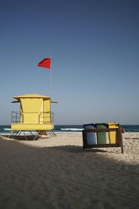 Lifeguard hut on beach against clear sky