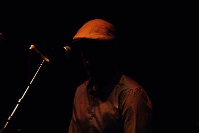 Midsection of man in black at night