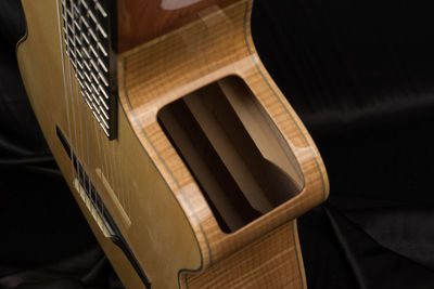 High angle view of guitar on bed