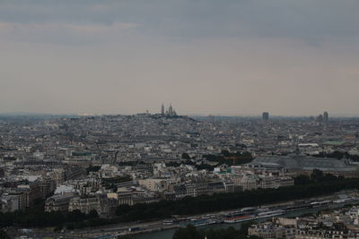 High angle view of city against cloudy sky