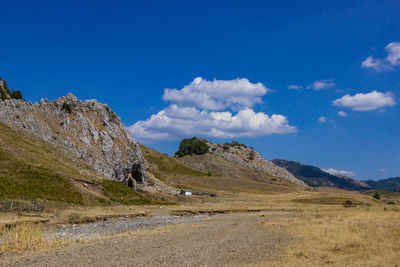 Scenic view of mountains against blue sky