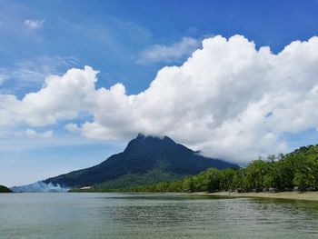 Scenic view of sea and mountains against sky