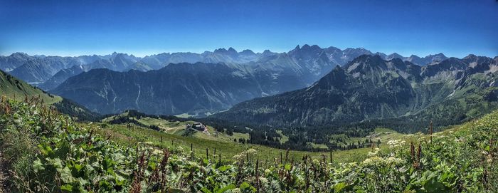 Panoramic view of mountains against blue sky