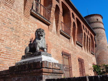 Low angle view of statue against building