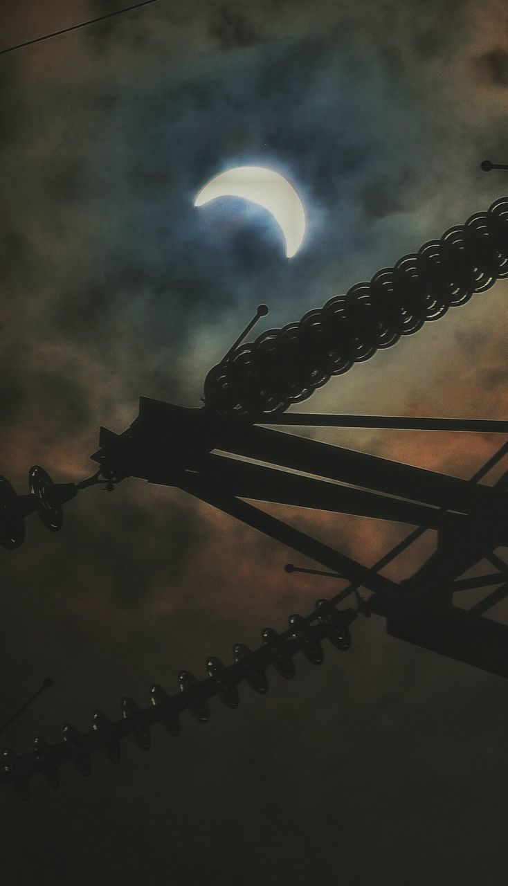 sky, low angle view, night, cloud - sky, silhouette, illuminated, architecture, built structure, dusk, weather, cloudy, connection, outdoors, overcast, no people, lighting equipment, building exterior, cloud, storm cloud, moon