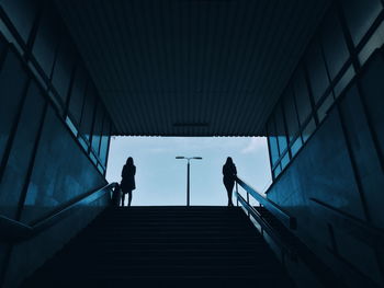 Low angle view of people walking on stairs