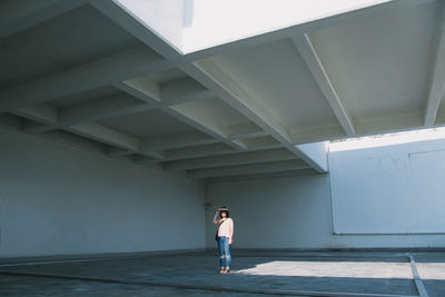 Full length rear view of man walking in corridor