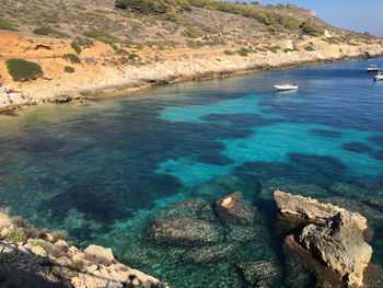 High angle view of rocks by sea