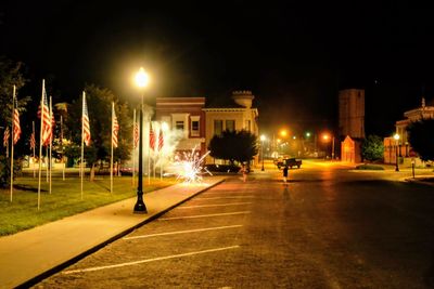 Illuminated city street at night