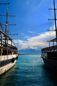 Sailboat sailing on sea against sky