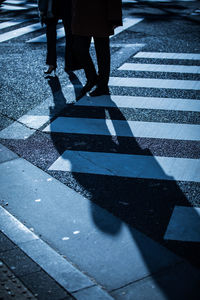 Low section of people walking on road