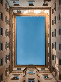 Low angle view of buildings against blue sky