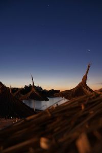 Scenic view of beach against clear sky at night