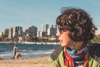 Woman on beach against sky