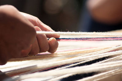 Cropped image of person working in handloom