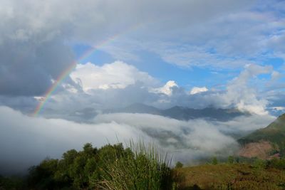 Low angle view of rainbow over mountain against sky