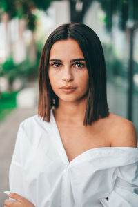 Woman wearing off shoulder top standing outdoors