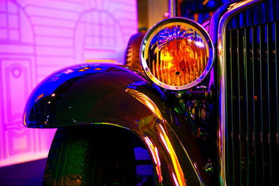 Close-up of illuminated ferris wheel at night