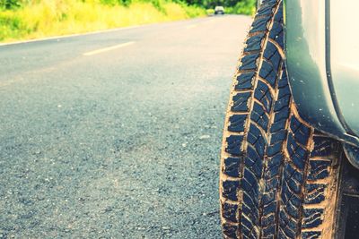 Close-up of tire track on road