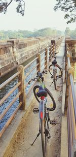 Bicycle parked by railing in city