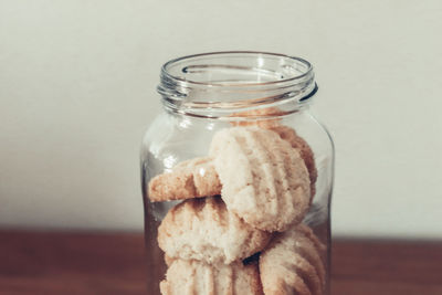 Close-up of cookies in glass jar on table