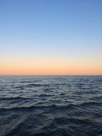 Scenic view of sea against clear sky during sunset