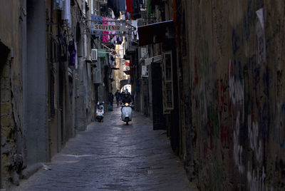 Narrow street amidst buildings in city