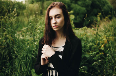 Portrait of beautiful young woman standing outdoors