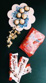 High angle view of hand holding ice cream over black background